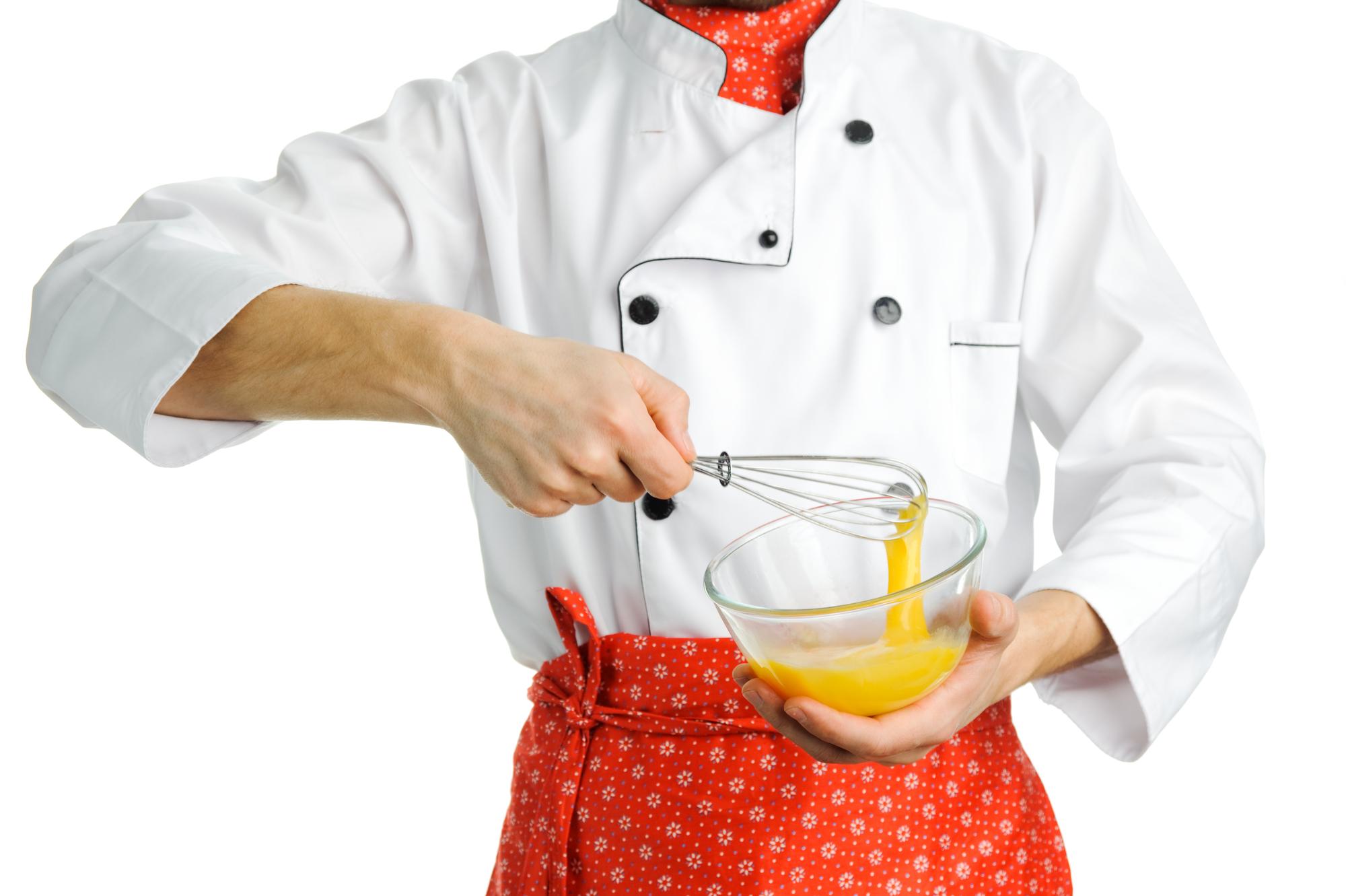 Hands whisking sauce in bowl